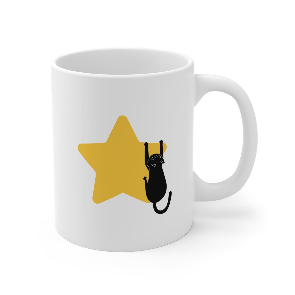 A white ceramic mug with a yellow star and a black cat illustration printed on the side, shown against a plain white background.