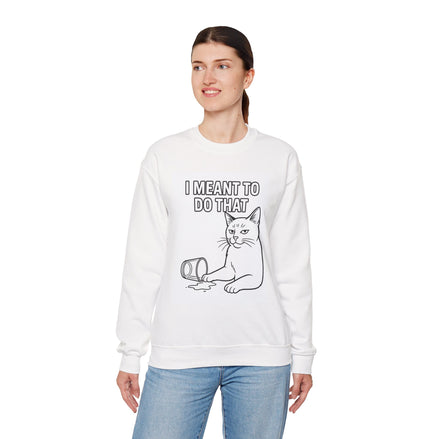 A woman modeling a white crewneck sweatshirt with a black line art graphic of a cat next to a spilled mug and the text 'I MEANT TO DO THAT'.