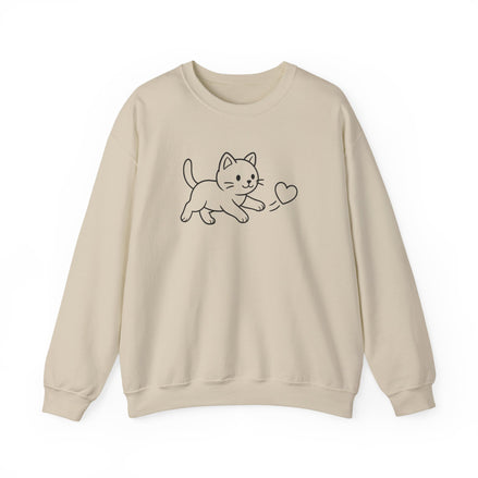 A beige crewneck sweatshirt featuring a simple black line art graphic of a kitten playing with a heart on the chest, displayed against a clean white background.