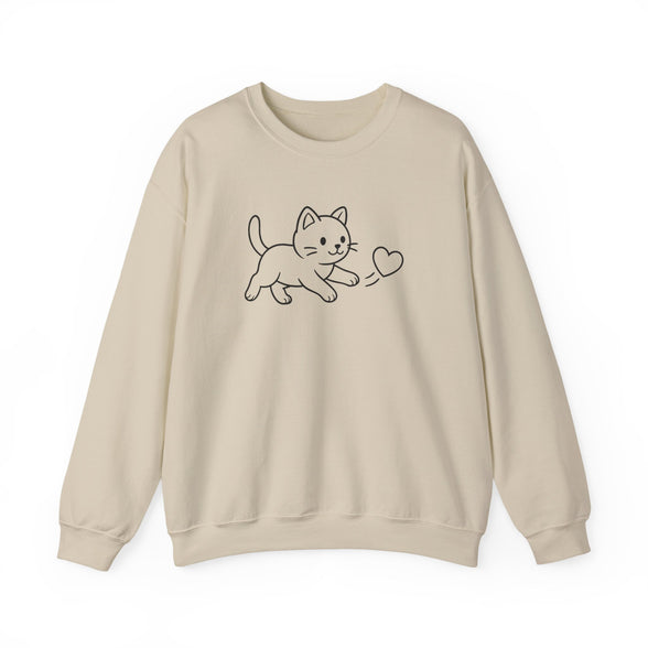 A beige crewneck sweatshirt featuring a simple black line art graphic of a kitten playing with a heart on the chest, displayed against a clean white background.