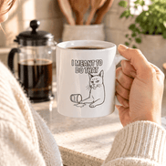 I Meant To Do That Cat Mug held by woman in a sweater.