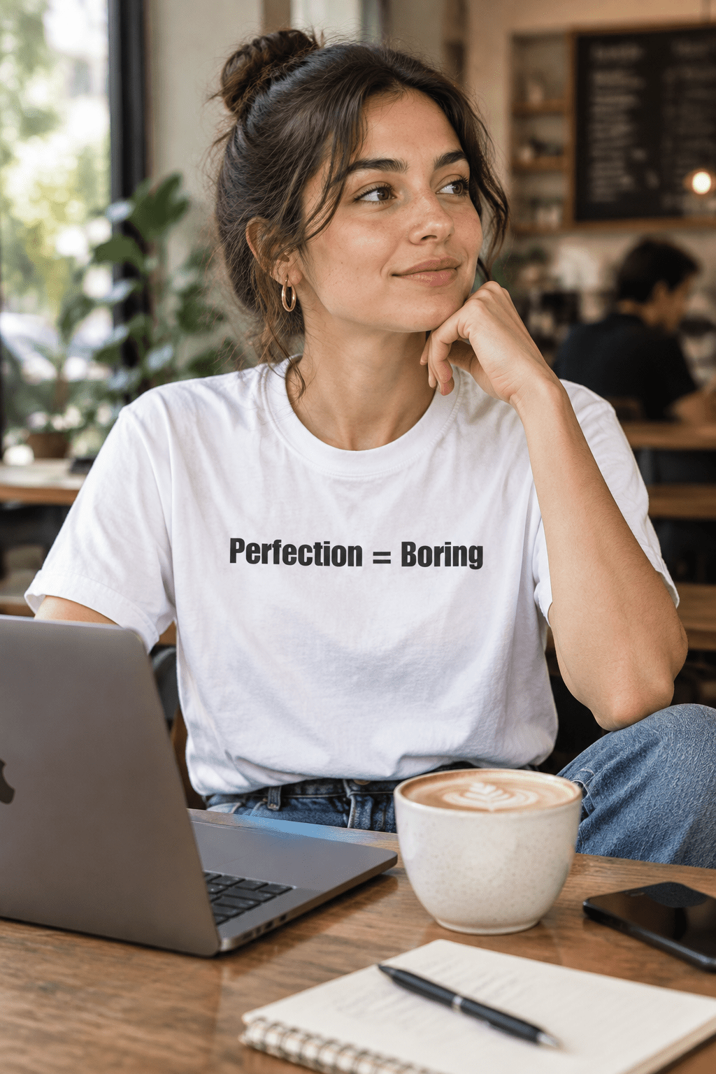 Perfection = Boring tee worn by a woman in a coffee shop