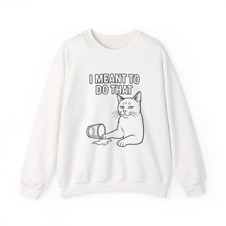 An off-white crewneck sweatshirt featuring a black line art graphic of a cat with a sad expression next to a spilled can, with the text 'I MEANT TO DO THAT' printed above.